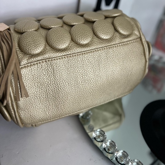 unique design with embossed circular details and a structured, metallic handle. - Picture 6 of 12